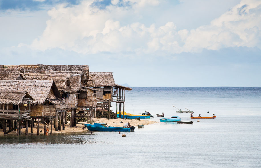 Thatched roof houses built on the beach in Malaita, Solomon Islands